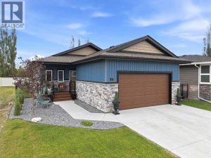 The attractive curb appeal features stylish siding, stone accents, and a composite front porch with a black metal railing
