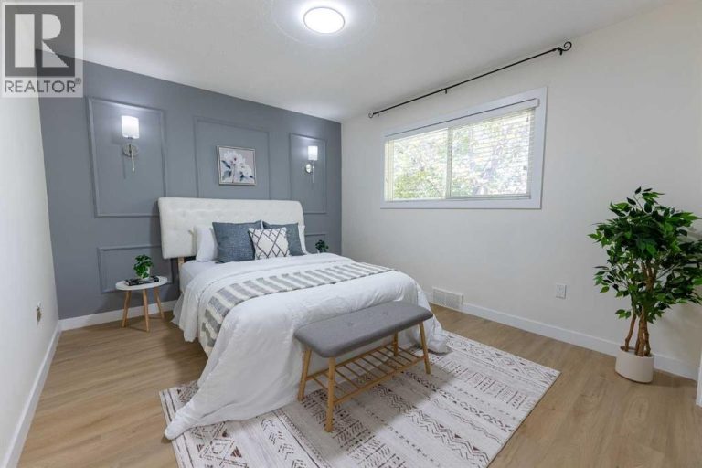 spacious primary bedroom with new feature wall