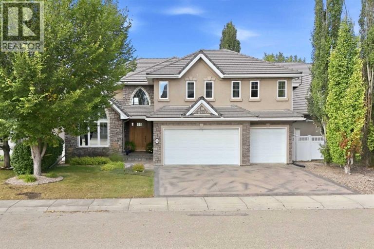 Exceptional curb appeal features a stone and stucco exterior, cement roof tiles, stamped concrete driveway and professional landscaping