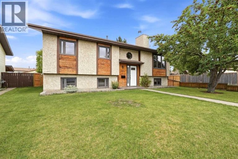 Great curb appeal welcomes you with a stucco exterior, wood trim accents, and a beautiful front crab apple tree