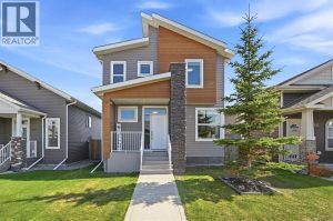 Modern rooflines, wood-grain siding accents, a covered composite front porch, and stone detailing create impressive curb appeal