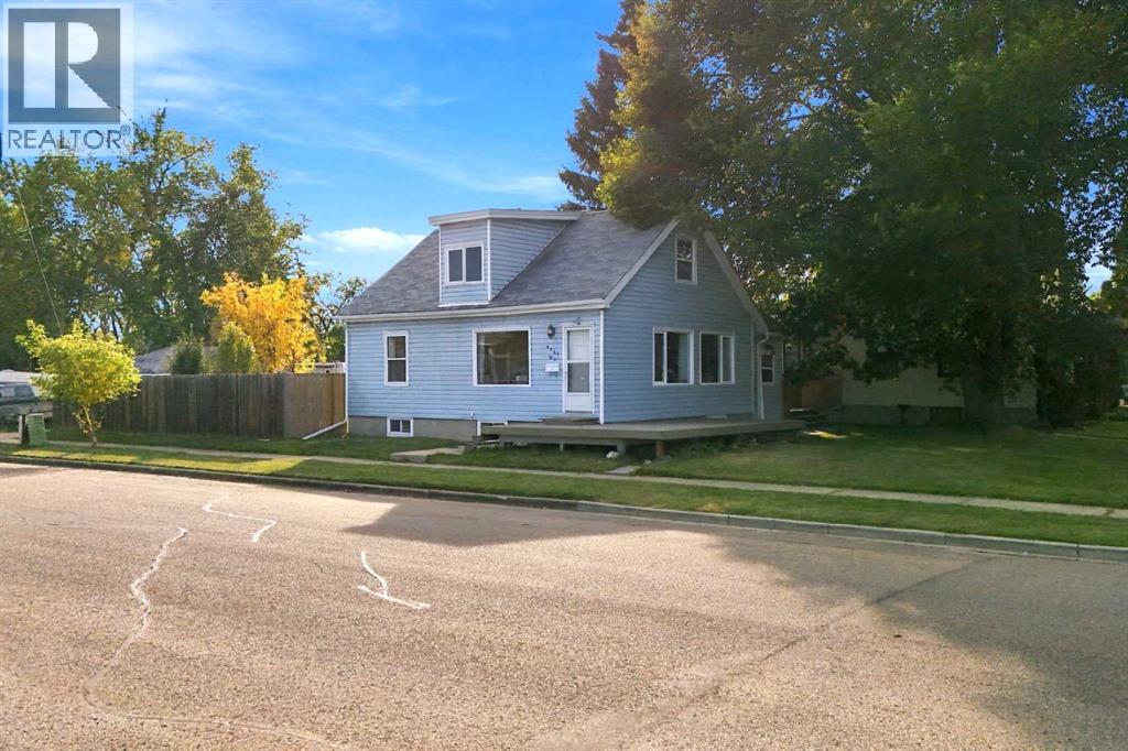 A pitched roof and large wraparound front porch create an inviting curb appeal