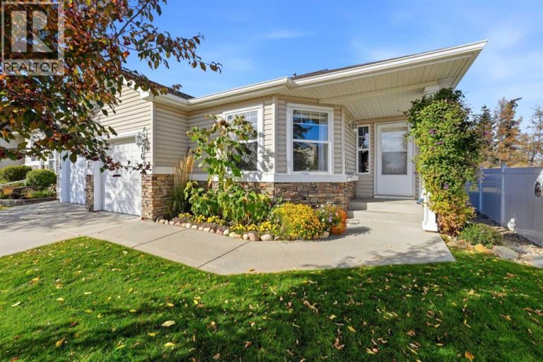 Beautiful front garden beds, a mature tree, and well-maintained landscaping create great curb appeal, with exterior maintenance taken care of for easy, low-maintenance living