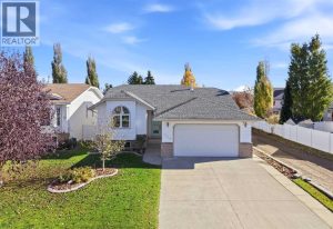 The home boasts fantastic curb appeal with attractive front landscaping, concrete garden bed edging, and brick accents